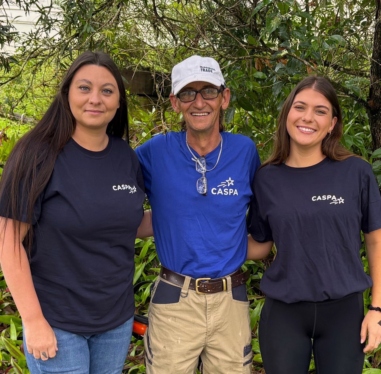 Three CASPA staff standing together outside, smiling