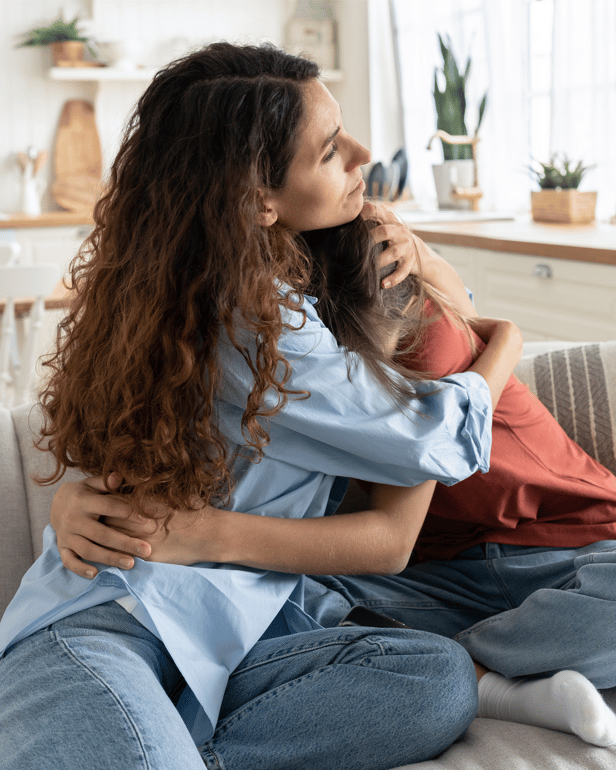 Mum comforts daughter on couch-1